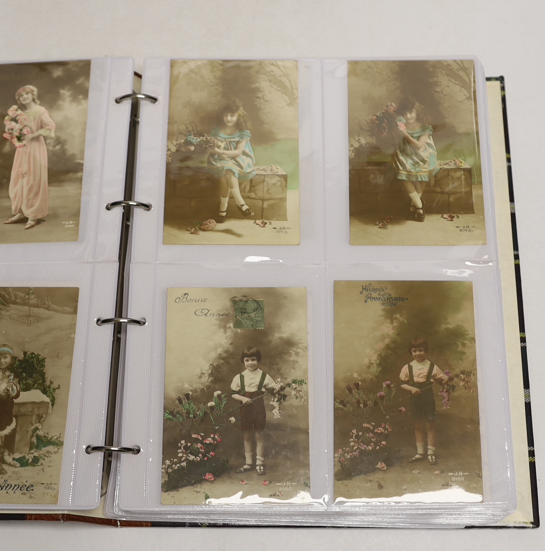 A large quantity of postcards, 940 total in three albums, all French, early 20th century